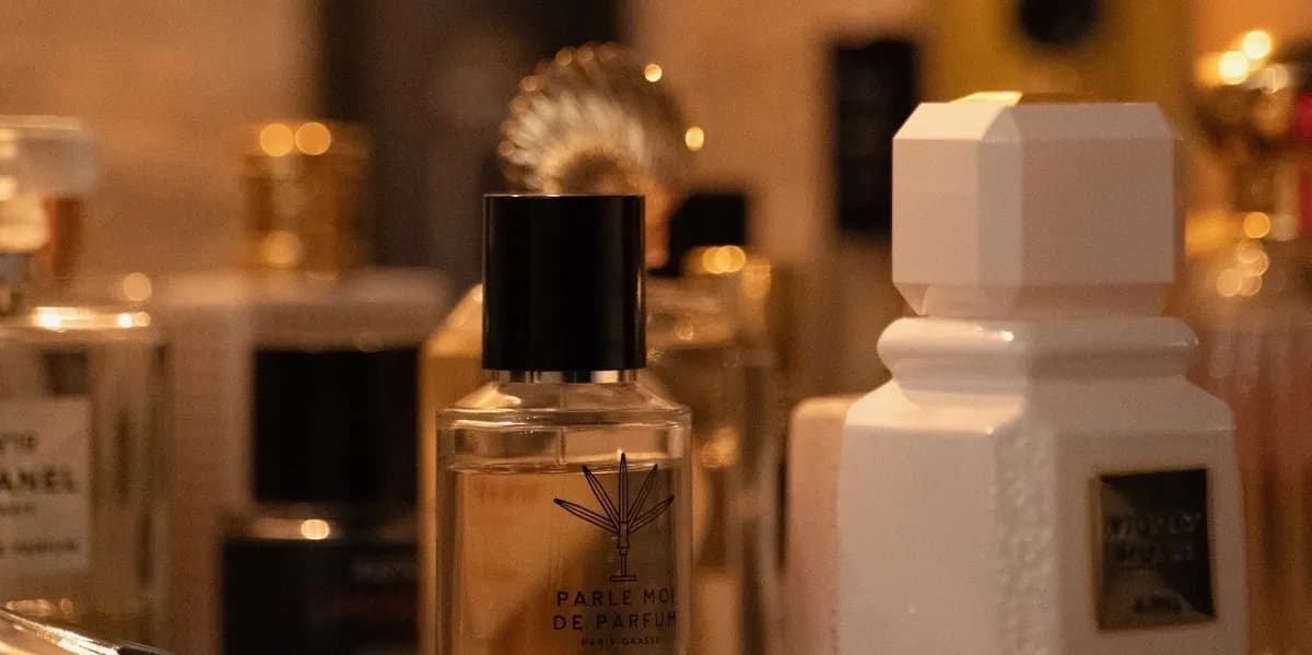 Niche perfume bottles gathered close together in warm golden light