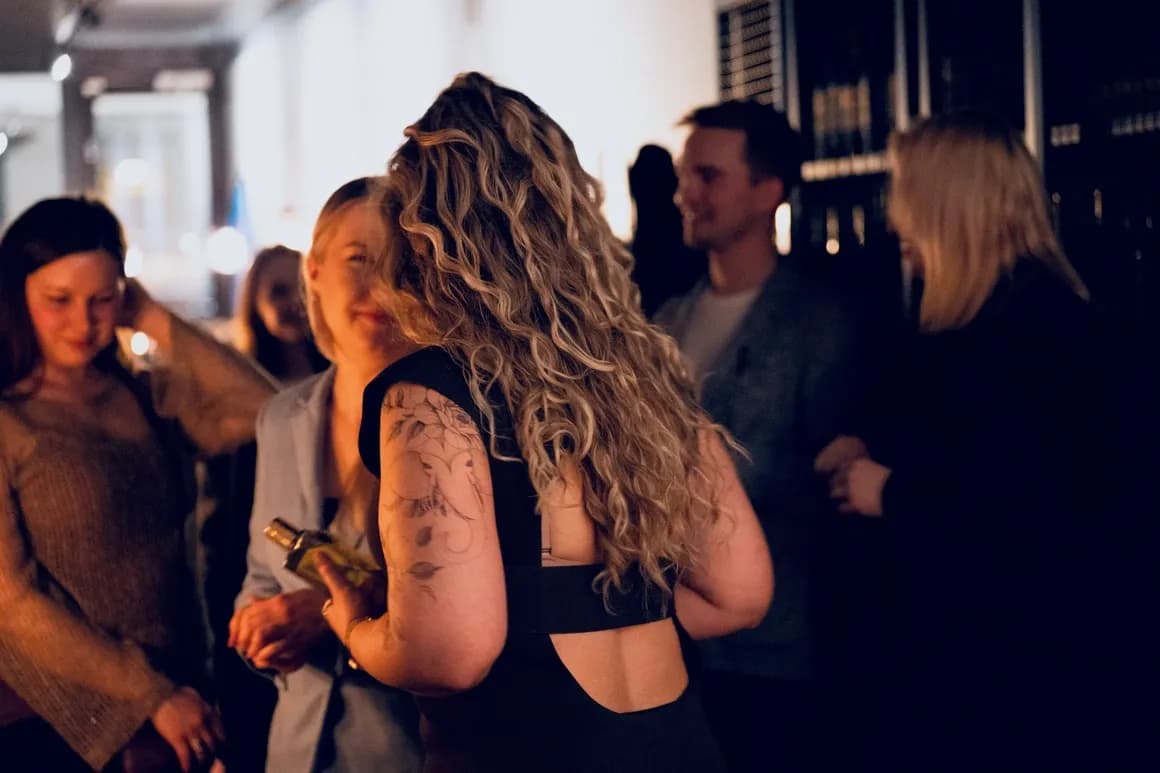 Members of Helsinki Perfume Club talking at an evening event